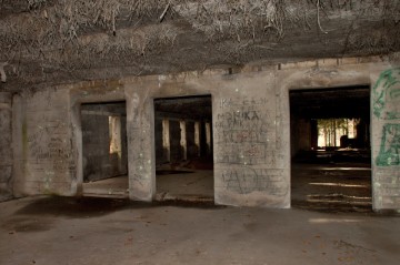 Pohled od menších místností směrem do haly. Po pravé straně fotografie je v zadní části otvor v cihlové stěně – viz foto ze sklepa.